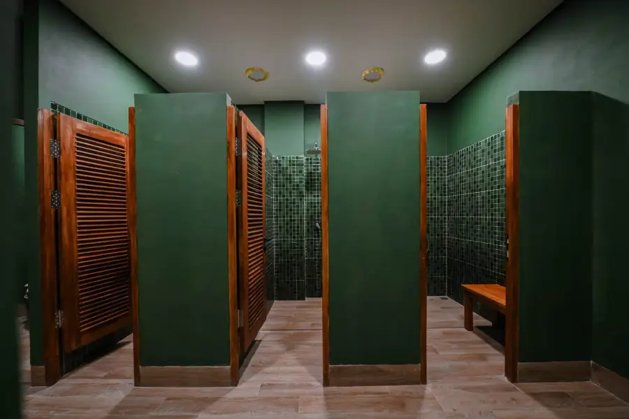 Dark green changing cubicles with timber doors