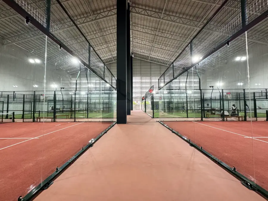Rows of glass courts under bright lights